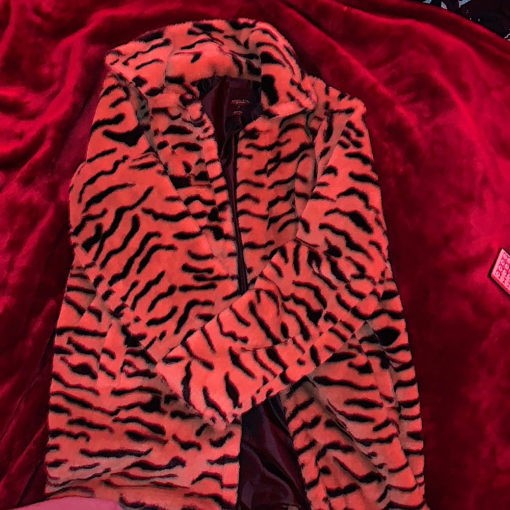 Faux fur Tiger striped. Black silk lining. Size small. Brand name is angle kiss.